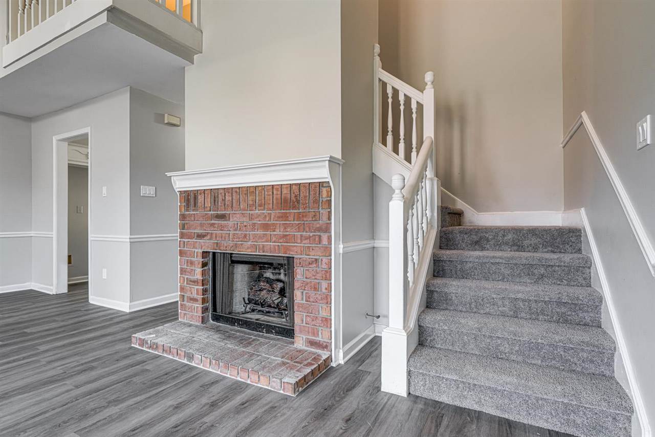 6853 Snyder Road Memphis, TN 38141 - Photo 8 of 23 a view of staircase with fireplace and wooden floor