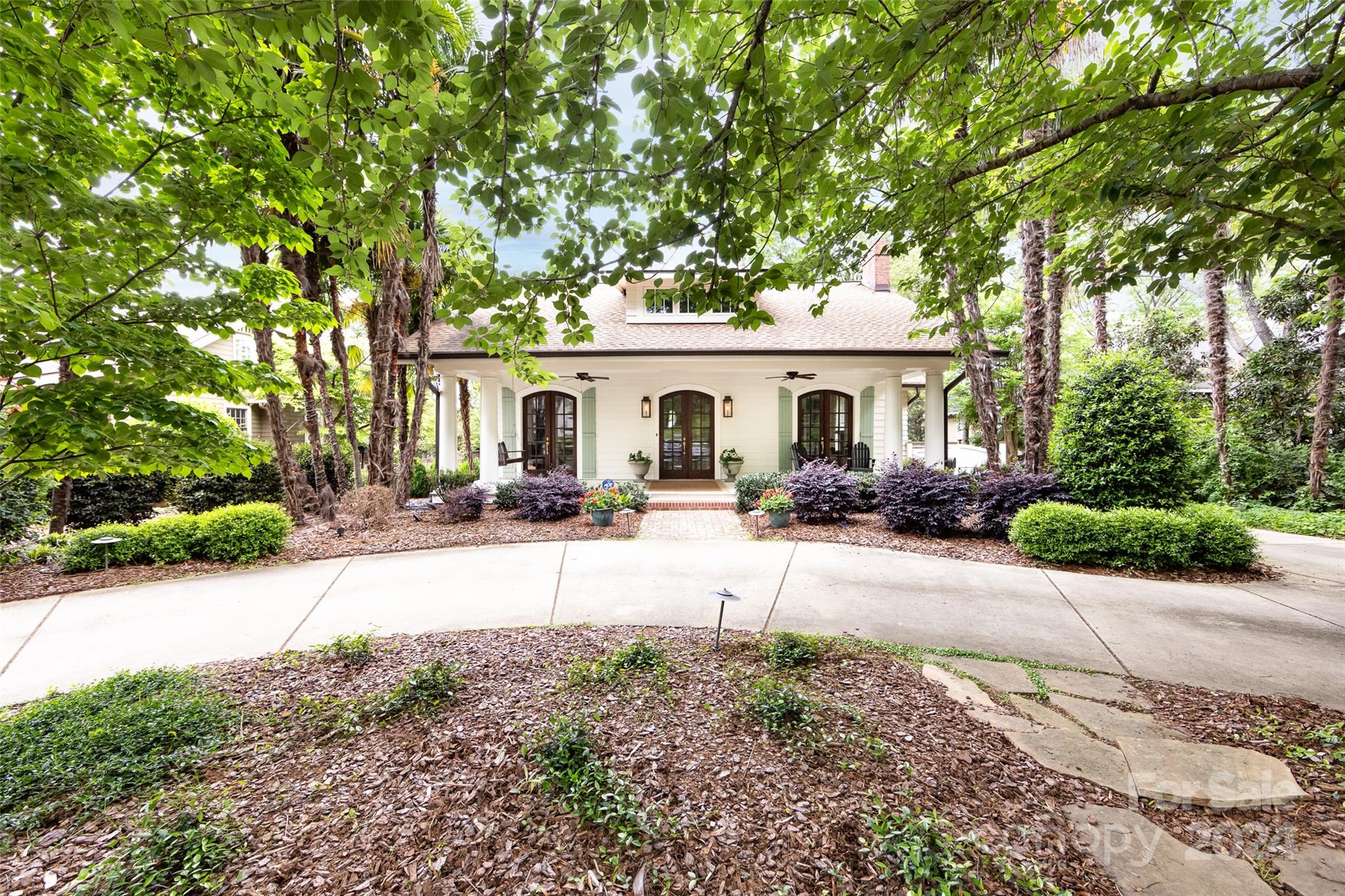 2310 Westfield Road Charlotte, NC 28207 - Photo 2 of 43 a view of a white house with a large tree and plants
