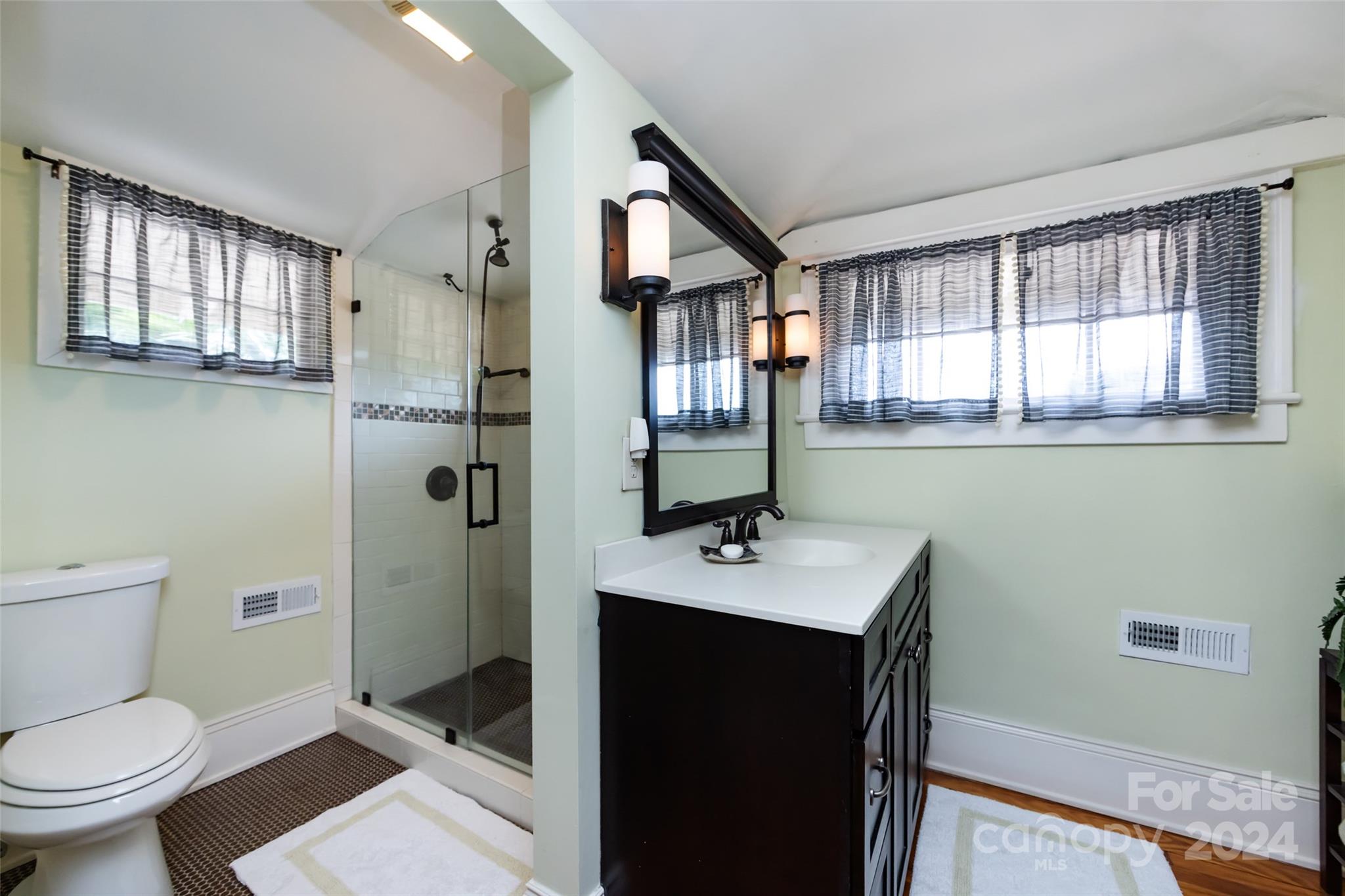 2310 Westfield Road Charlotte, NC 28207 - Photo 30 of 43 a bathroom with a toilet sink and mirror