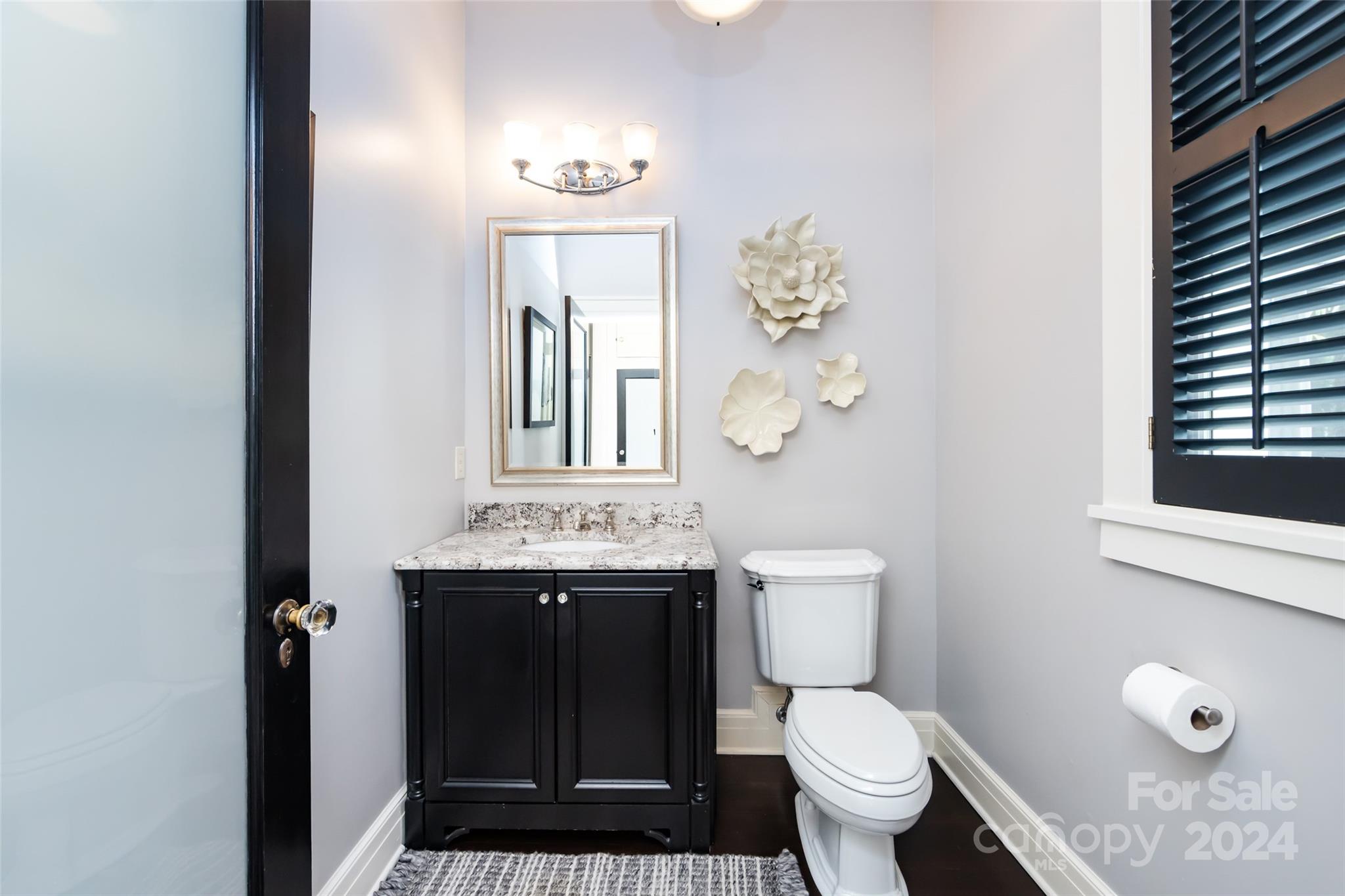 2310 Westfield Road Charlotte, NC 28207 - Photo 31 of 43 a bathroom with a toilet a sink and mirror