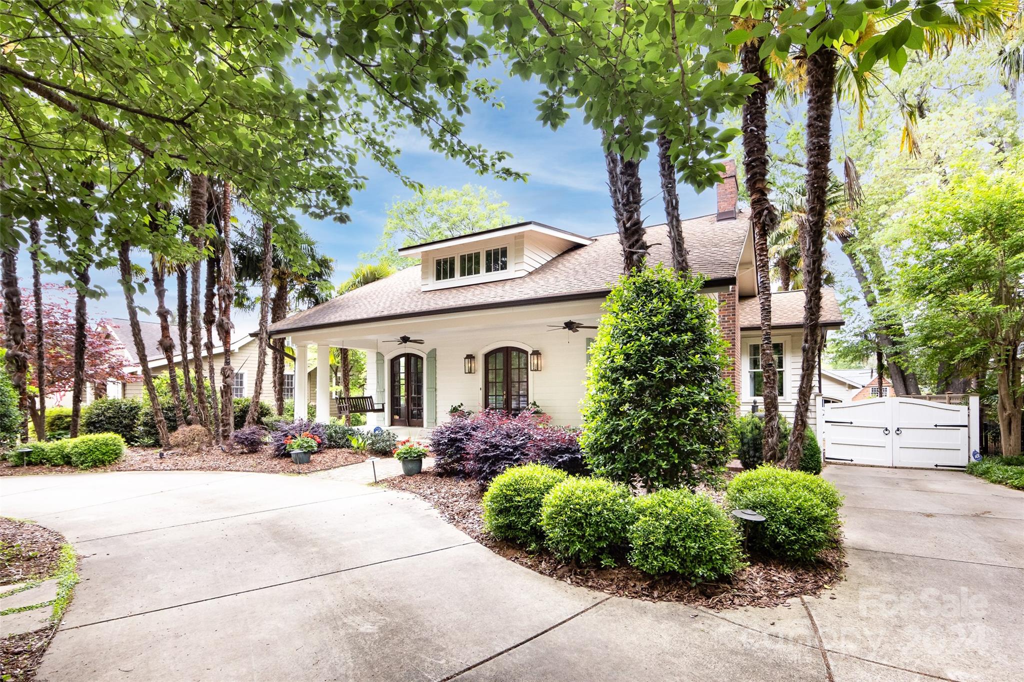 2310 Westfield Road Charlotte, NC 28207 - Photo 5 of 43 a front view of a house with a yard and potted plants