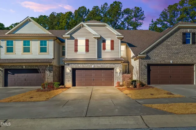 a view of a house with a yard and garage