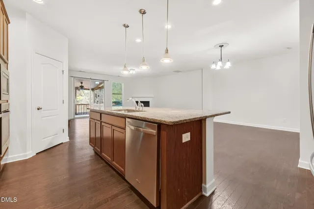 a kitchen with stainless steel appliances granite countertop a refrigerator and a sink
