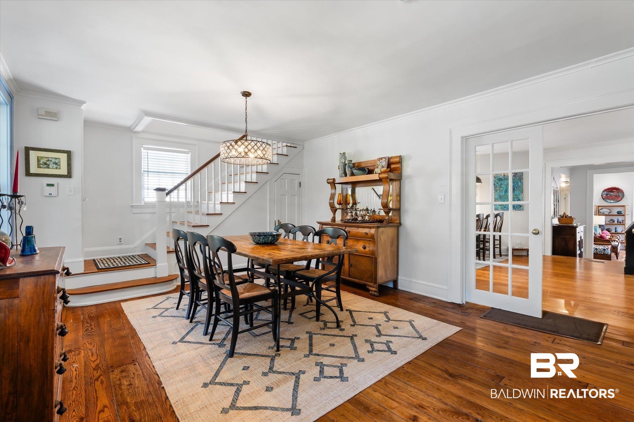 202 Woodlands Avenue Mobile, AL 36607 - Photo 5 of 53 Dining area featuring dark wood-type flooring, crown molding, and a chandelier
