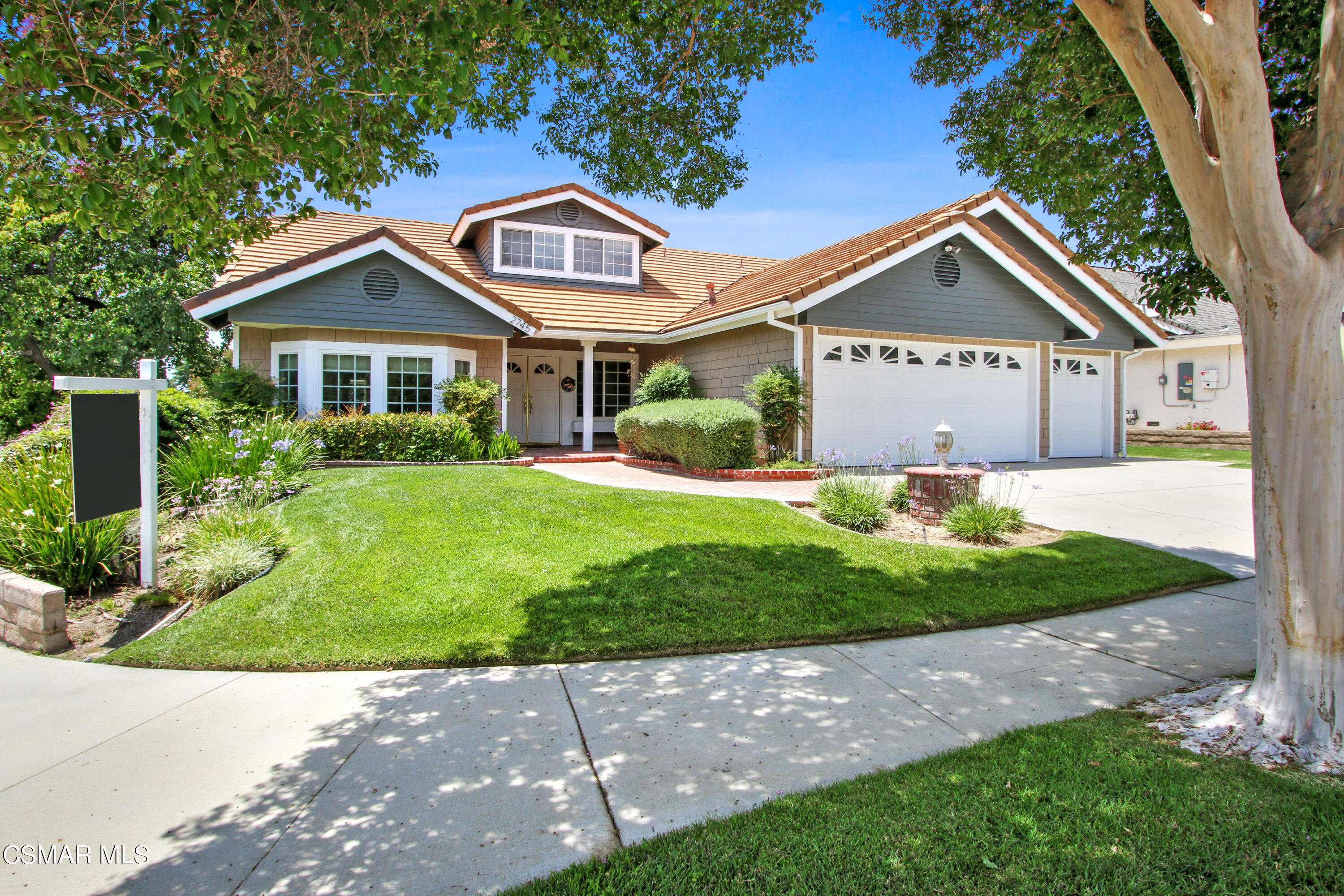 2745 Gum Circle Simi Valley, CA 93065 - Photo 7 of 40 a front view of a house with a yard and potted plants