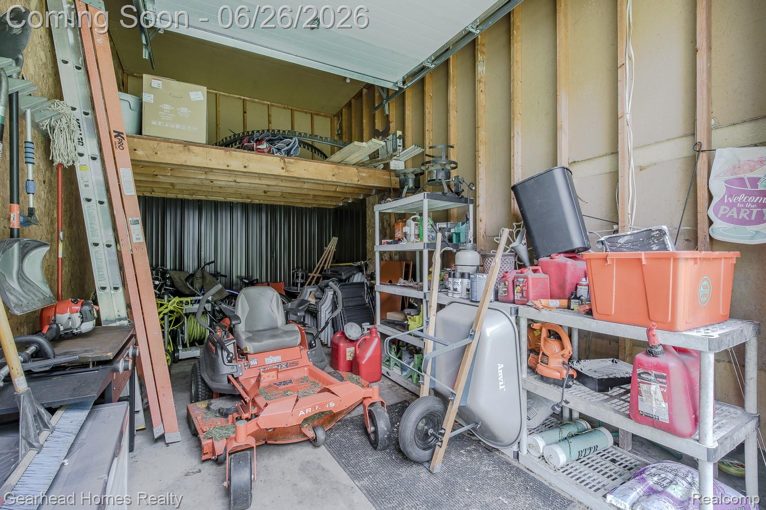 12364 Morrish Road Clio, MI 48420 - Photo 63 of 81 Detached garage featuring exposed wood stud walls, concrete flooring, and an overhead storage loft