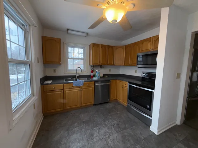 a kitchen with a sink stove and microwave