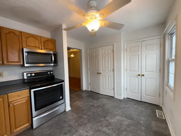 a kitchen with stainless steel appliances a stove a microwave and a refrigerator