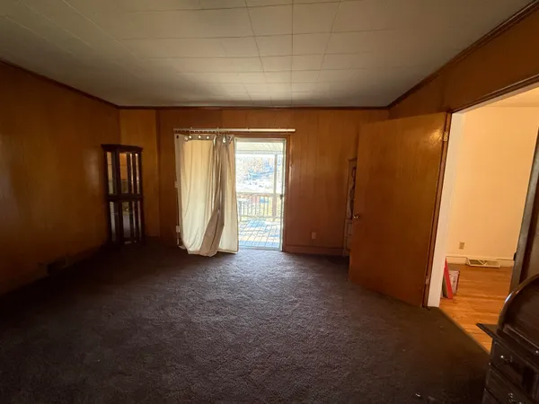 an empty room with closet and wooden floor