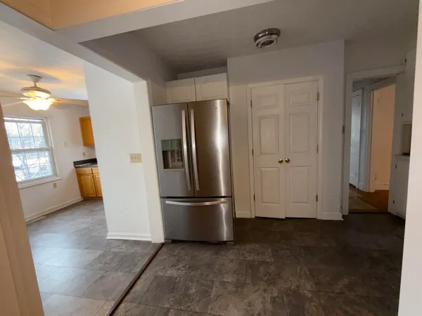 a view of empty room with closet and wooden floor