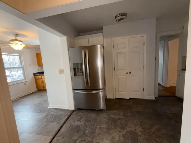 a view of empty room with closet and wooden floor