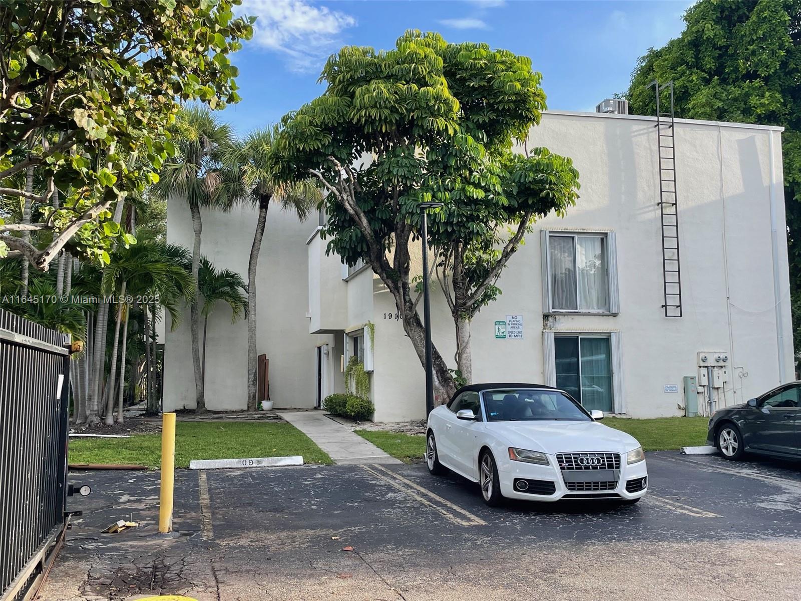 a car parked in front of white house