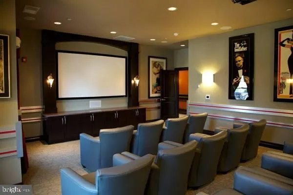 a media room with lots of chairs and a projector