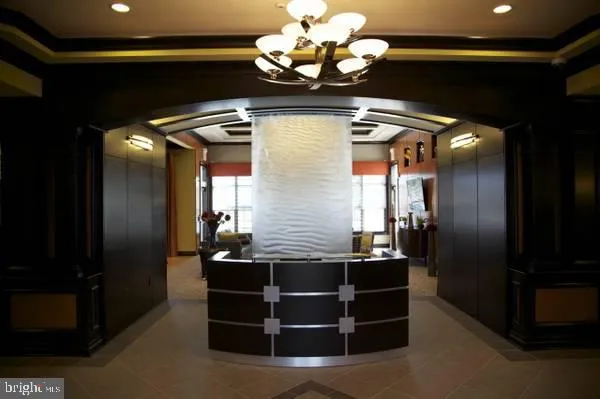 a kitchen with a refrigerator and a chandelier