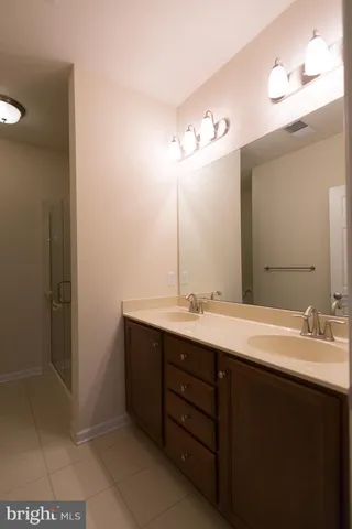 a bathroom with a double vanity sink and a mirror