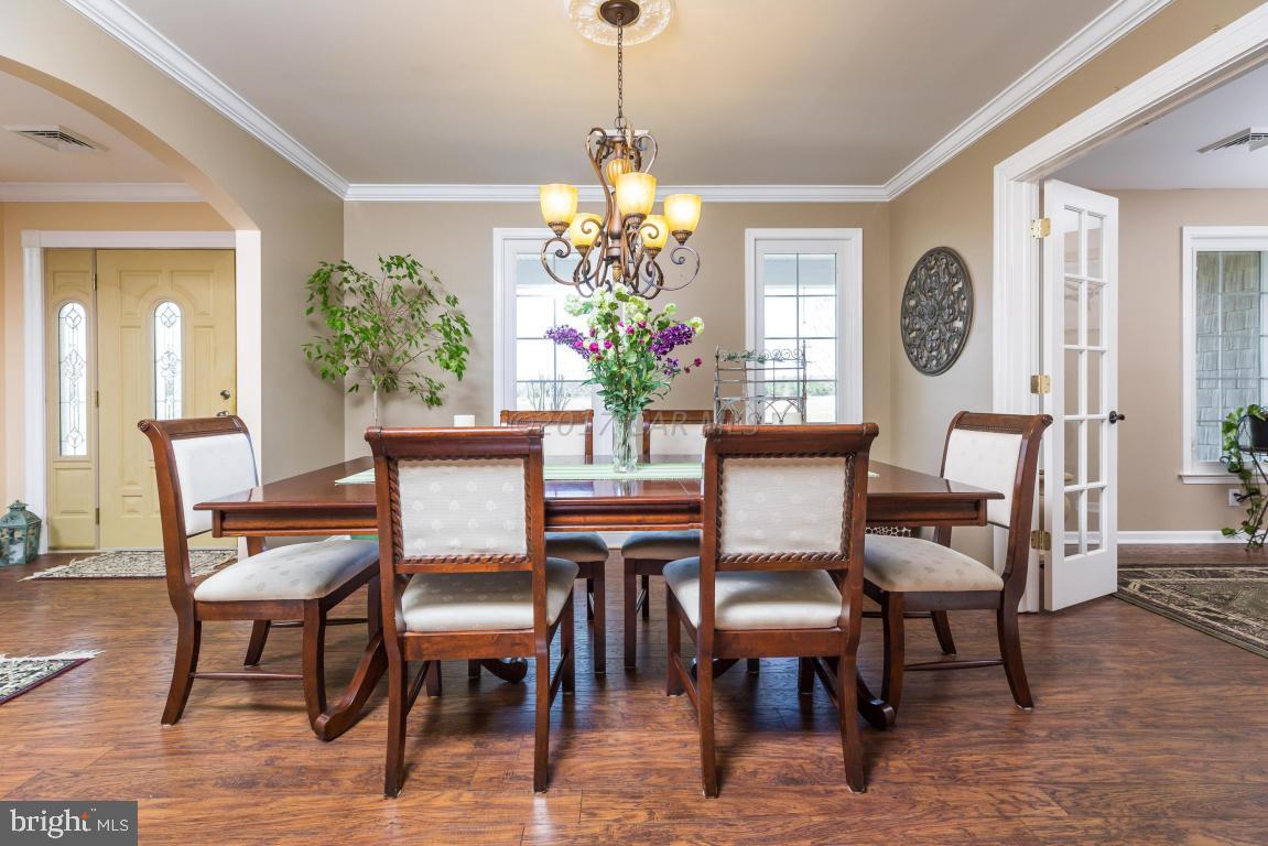 8639 Tindley Road Newark, MD 21841 - Photo 14 of 36 a view of a dining room with furniture window and wooden floor