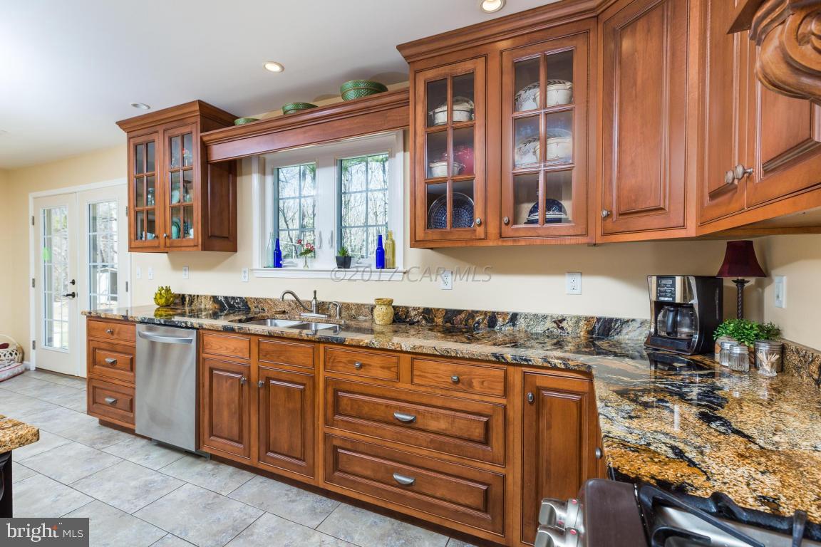 8639 Tindley Road Newark, MD 21841 - Photo 22 of 36 a kitchen with stainless steel appliances granite countertop a stove and cabinets
