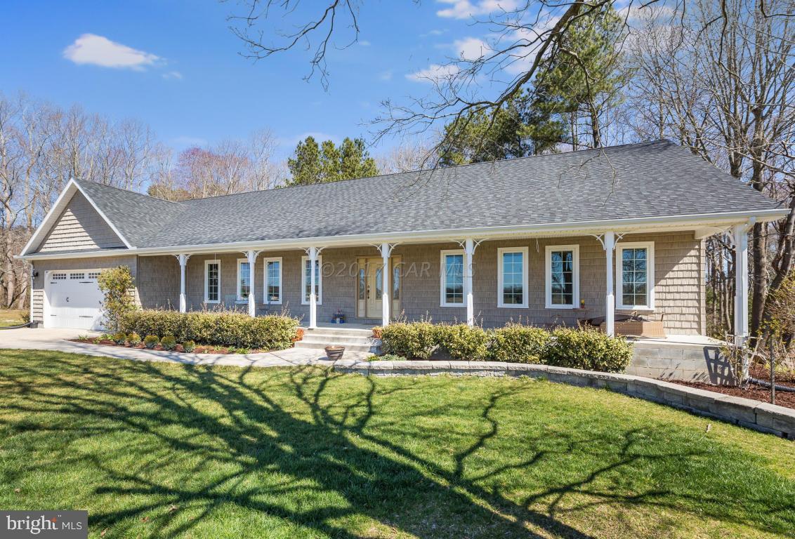 8639 Tindley Road Newark, MD 21841 - Photo 4 of 36 a front view of house with yard and outdoor seating