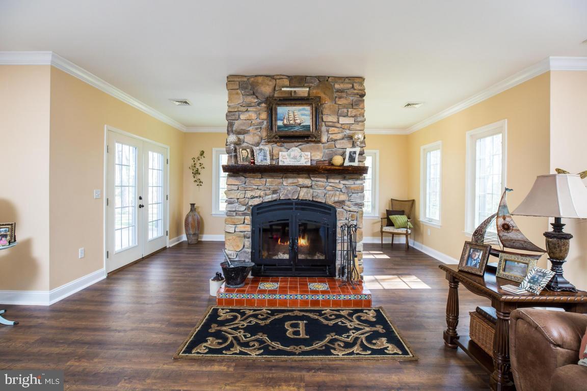8639 Tindley Road Newark, MD 21841 - Photo 8 of 36 a living room with furniture and a fireplace
