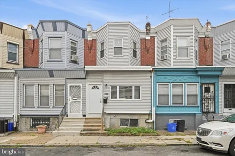 a front view of a residential apartment building with a yard