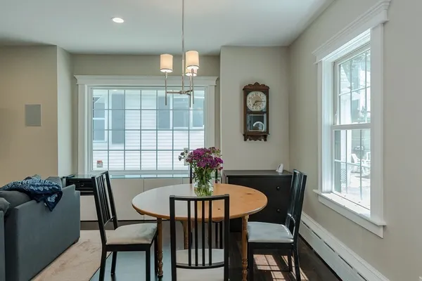 a dining room with furniture a chandelier and window