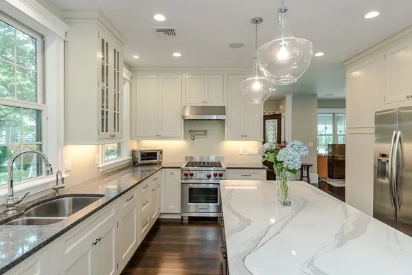 a kitchen with refrigerator and cabinets