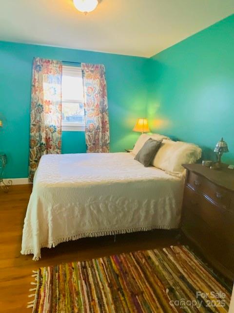 422 Mirror Lake Road Salisbury, NC 28146 - Photo 12 of 18 a bedroom with a bed and wooden floor