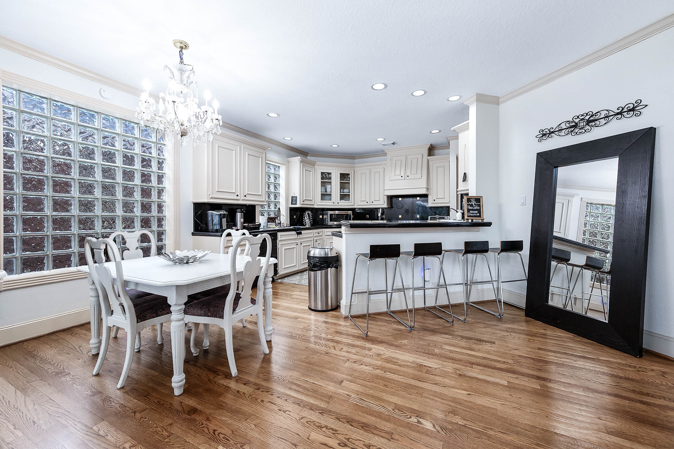 7110 Gary Street Houston, TX 77055 - Photo 11 of 50 a kitchen with stainless steel appliances granite countertop a stove top oven a sink dishwasher a dining table and chairs with wooden floor