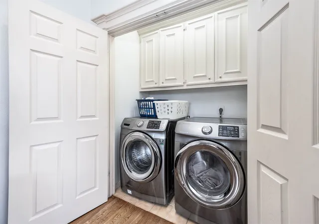 a utility room with sink dryer and washer