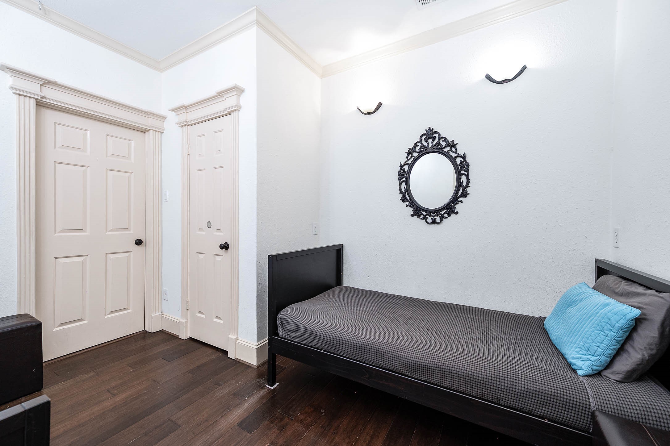 7110 Gary Street Houston, TX 77055 - Photo 26 of 50 a bedroom with a bed and wooden floor