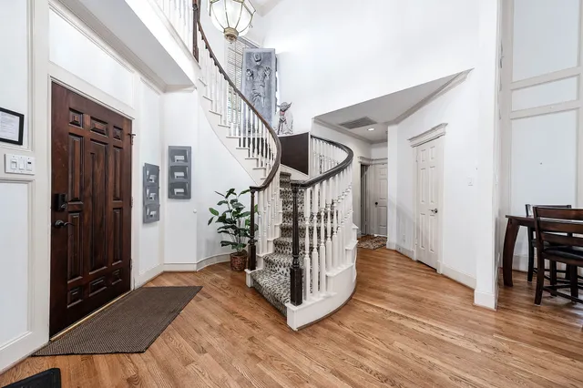 a view of entryway and hall with wooden floor