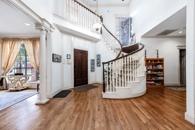 a view of entryway with wooden floor and windows