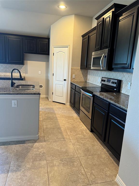236 Archer Way Forney, TX 75126 - Photo 10 of 35 a kitchen with stainless steel appliances granite countertop a stove refrigerator and sink