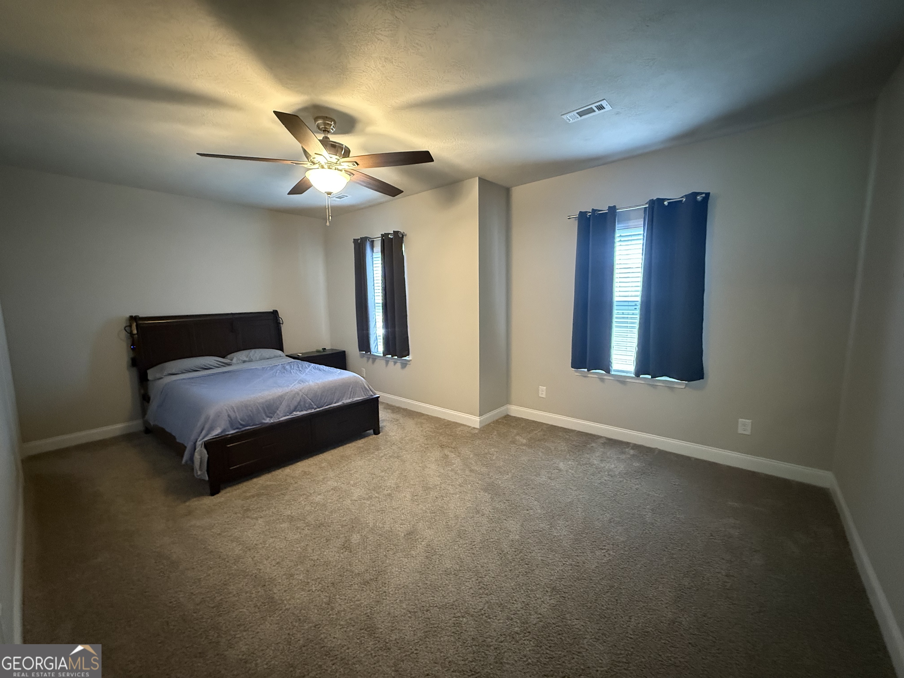 136 Pebble Lane Harlem, GA 30814 - Photo 18 of 30 a bedroom with a bed and a ceiling fan