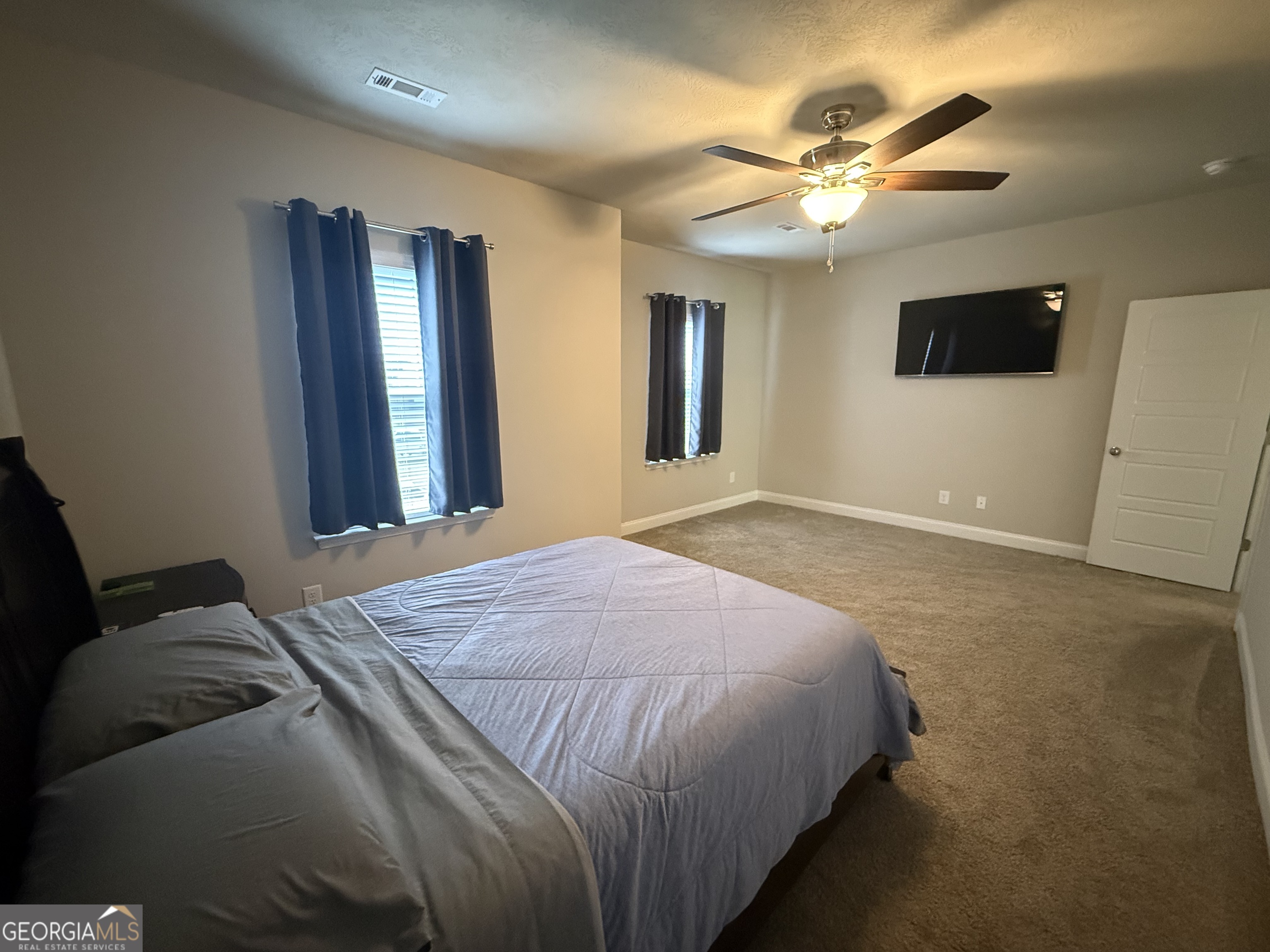 136 Pebble Lane Harlem, GA 30814 - Photo 19 of 30 a bedroom with a bed and a chandelier
