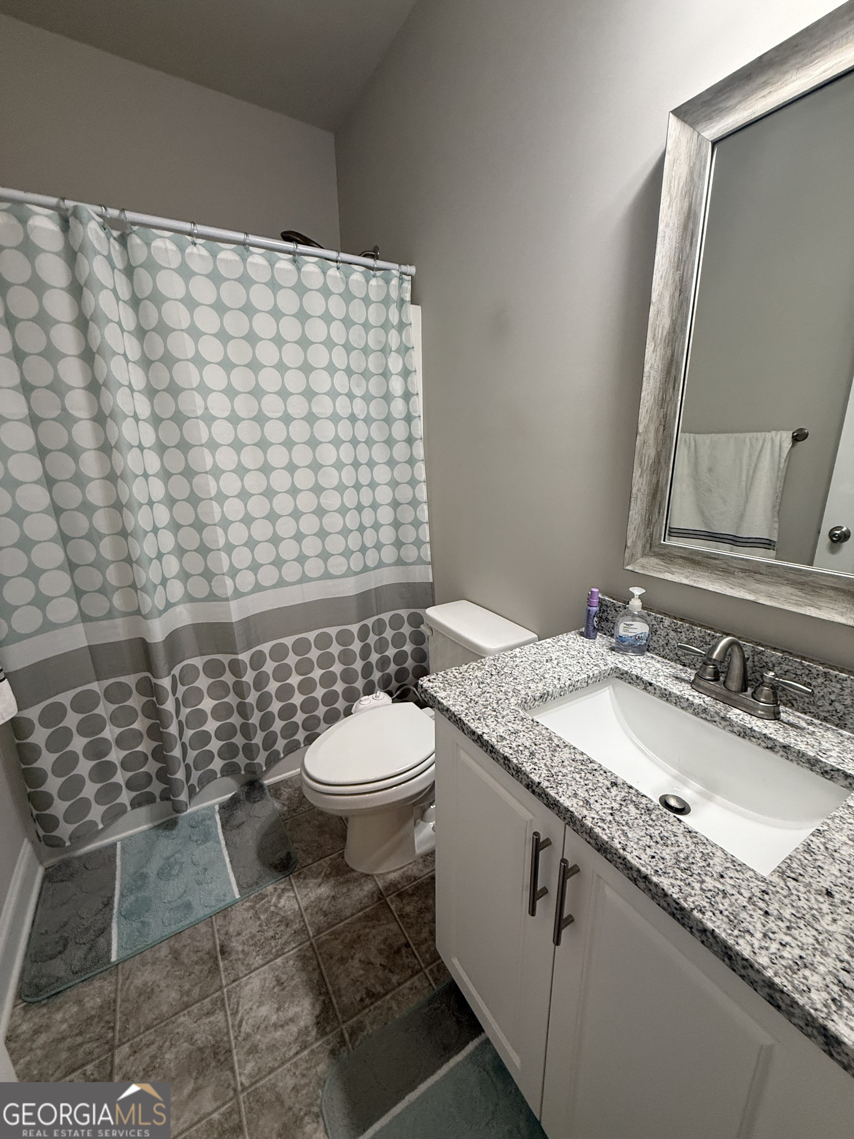 136 Pebble Lane Harlem, GA 30814 - Photo 22 of 30 a bathroom with a granite countertop toilet sink and mirror