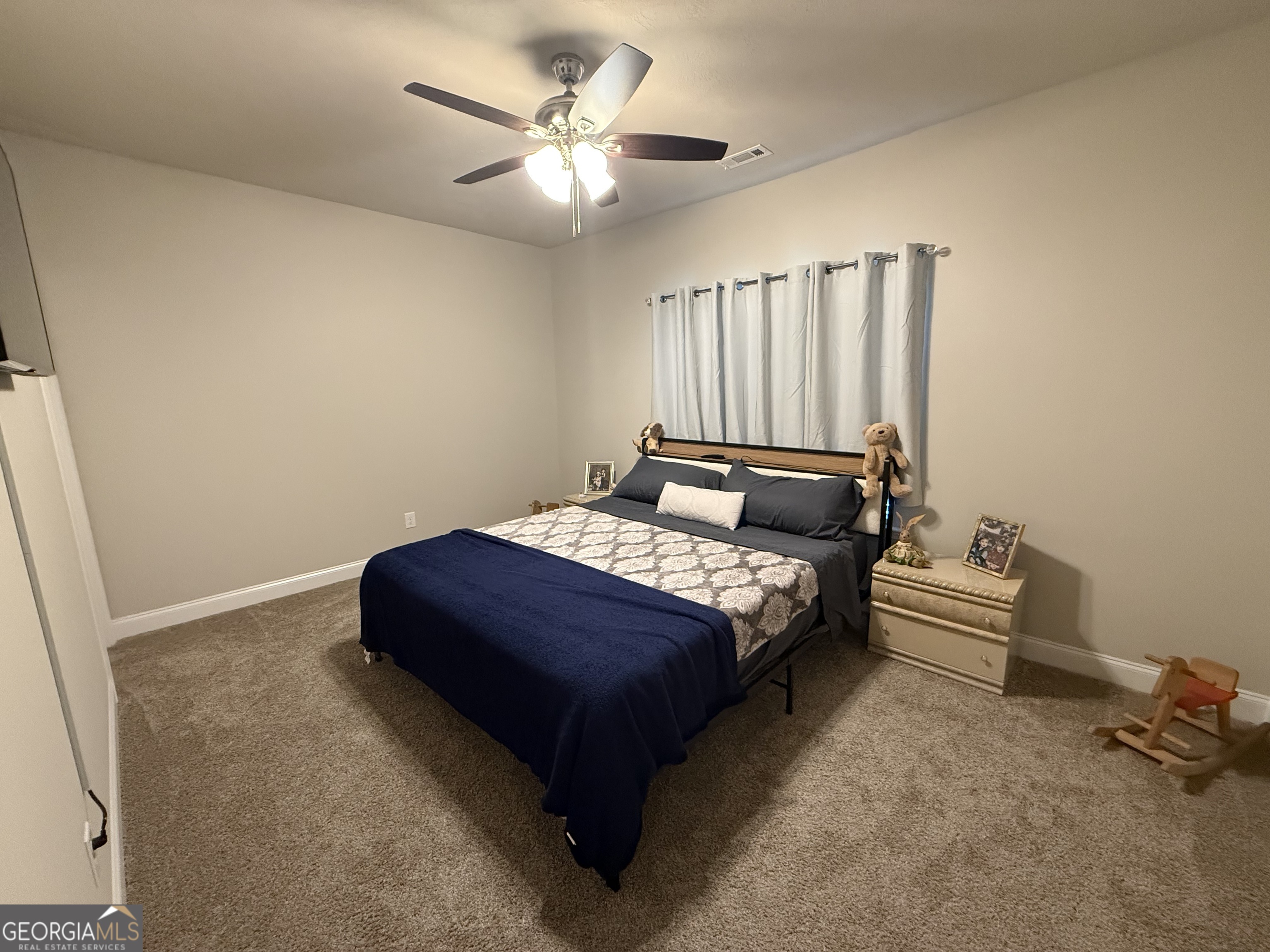 136 Pebble Lane Harlem, GA 30814 - Photo 23 of 30 a bedroom with a bed and a chandelier