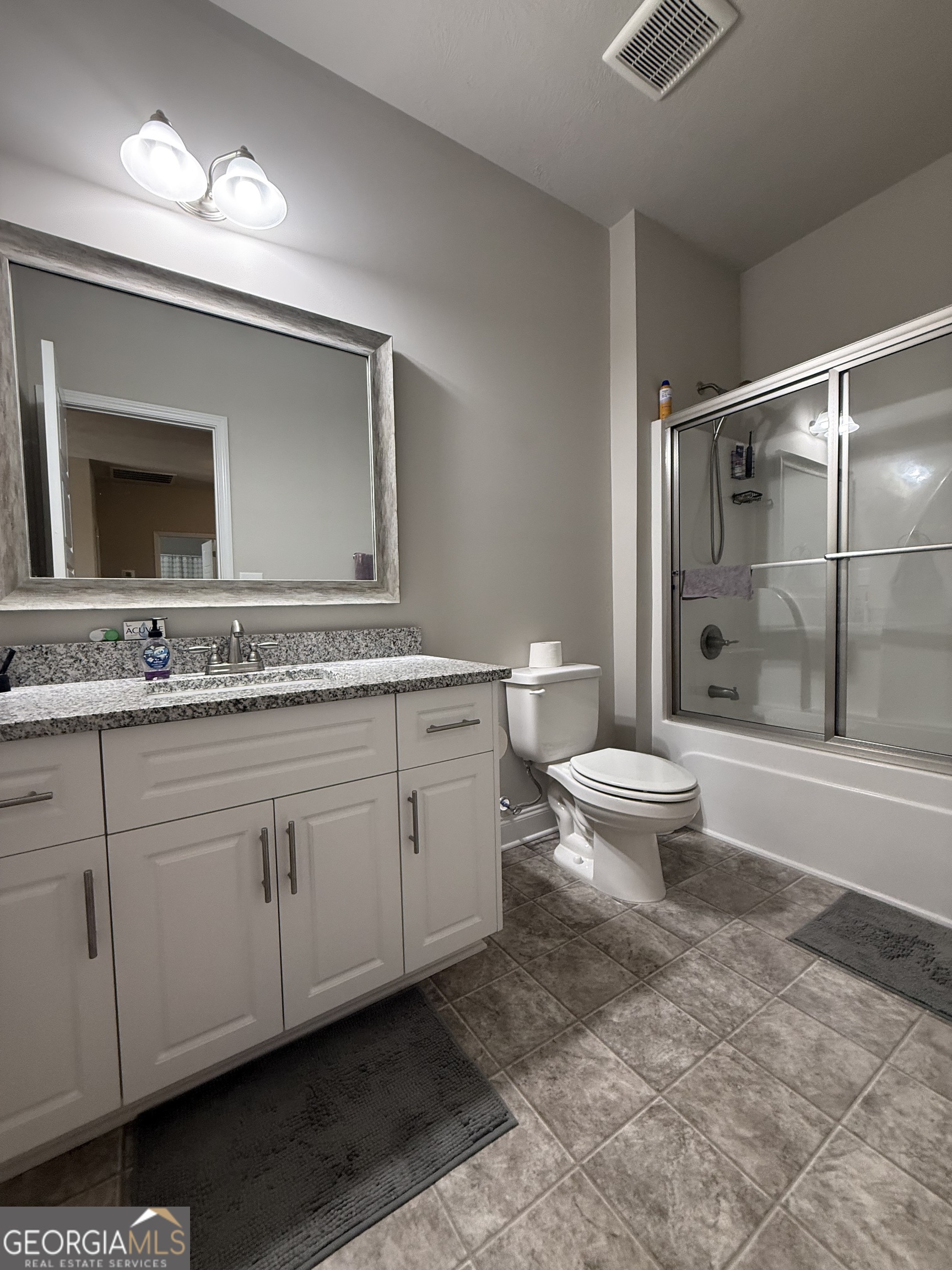 136 Pebble Lane Harlem, GA 30814 - Photo 27 of 30 a spacious bathroom with a granite countertop sink and a toilet