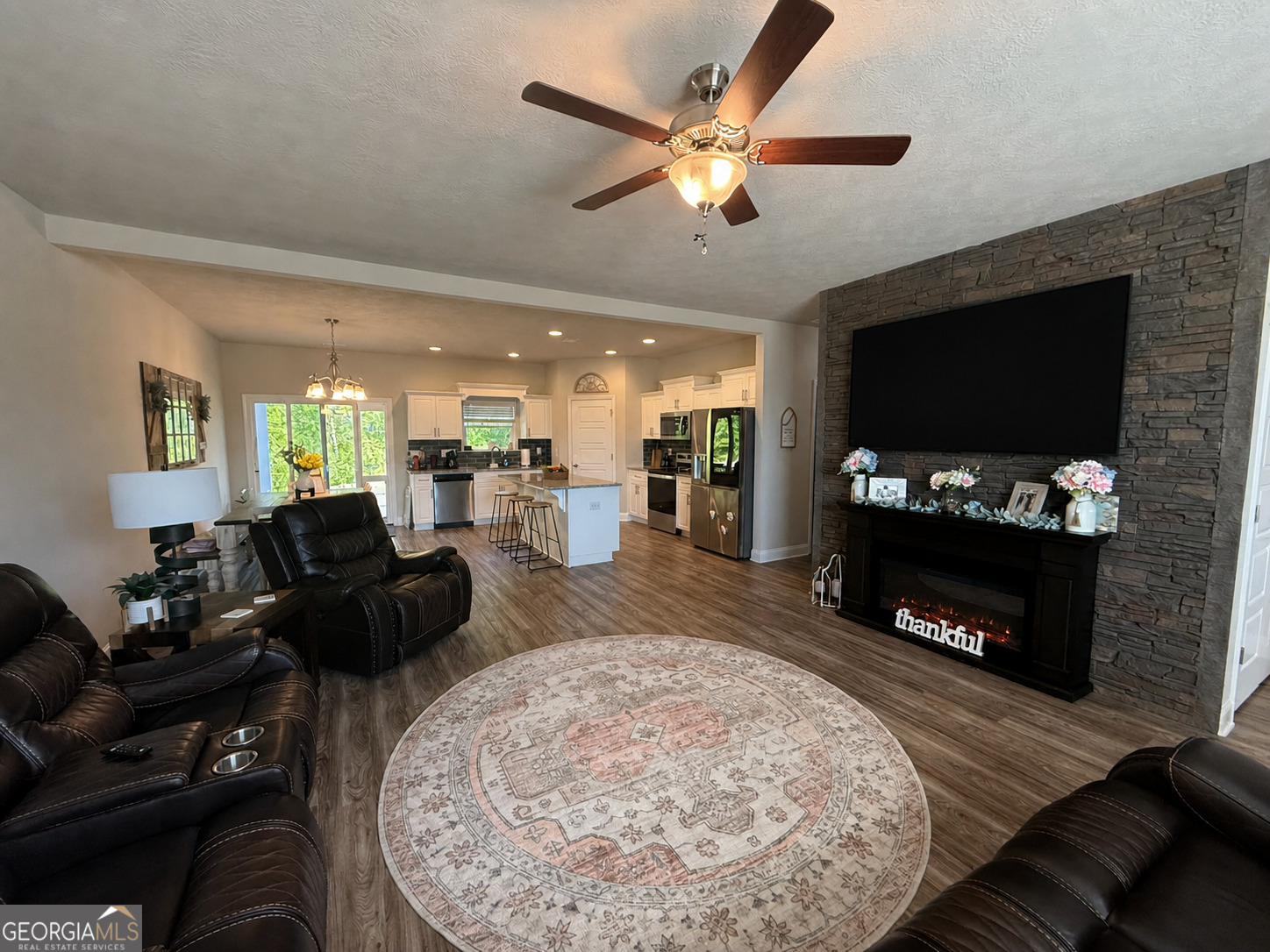 136 Pebble Lane Harlem, GA 30814 - Photo 5 of 30 a living room with furniture a flat screen tv and a fireplace