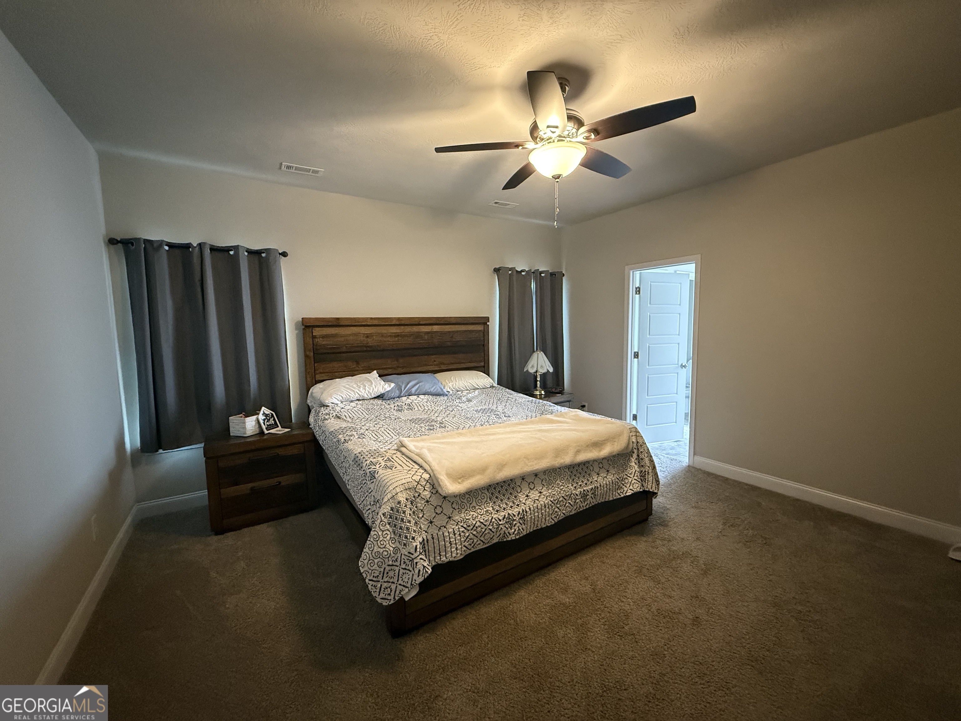 136 Pebble Lane Harlem, GA 30814 - Photo 8 of 30 a bedroom with a bed and a chandelier