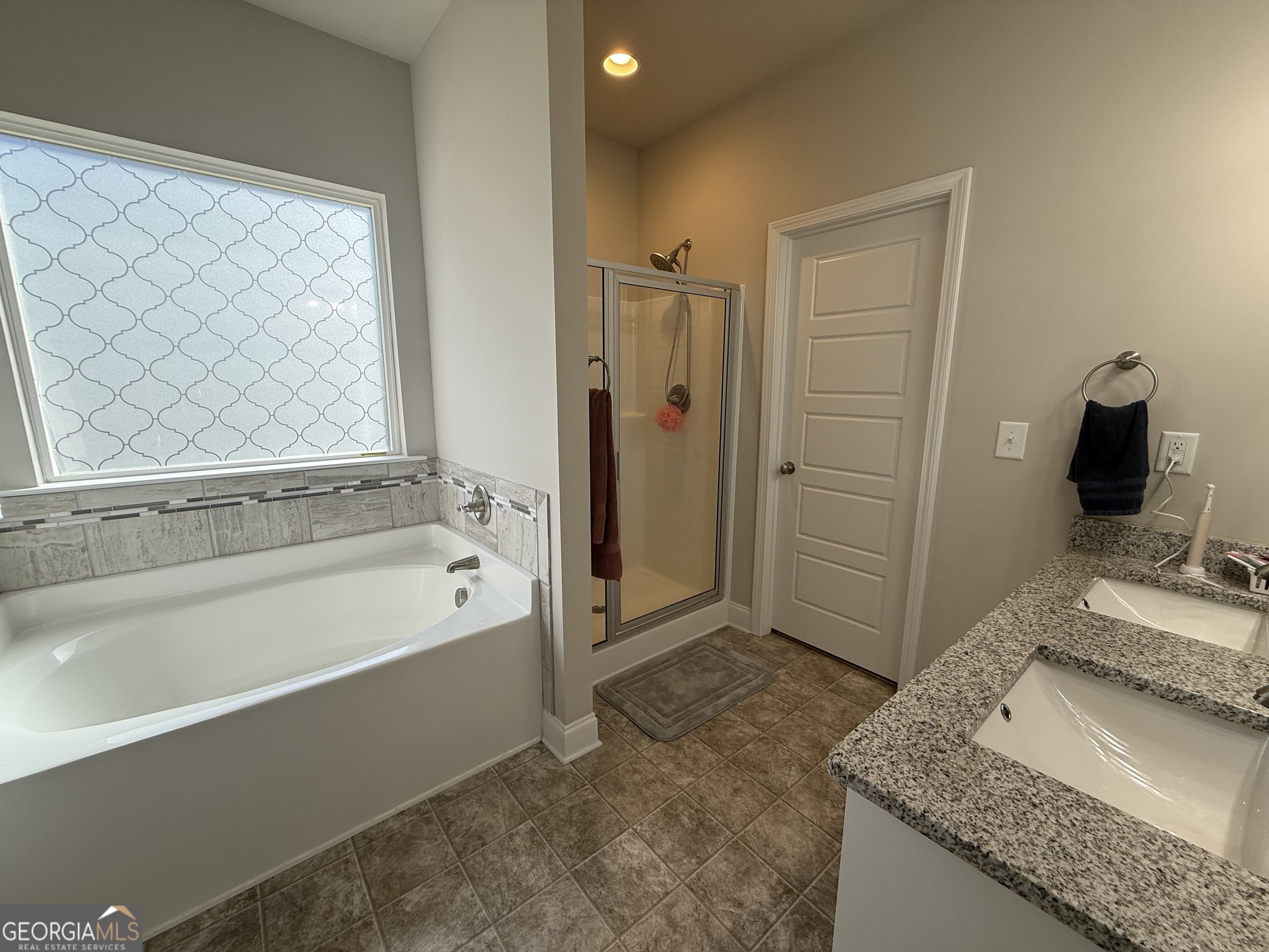 136 Pebble Lane Harlem, GA 30814 - Photo 9 of 30 a spacious bathroom with a granite countertop sink and a mirror