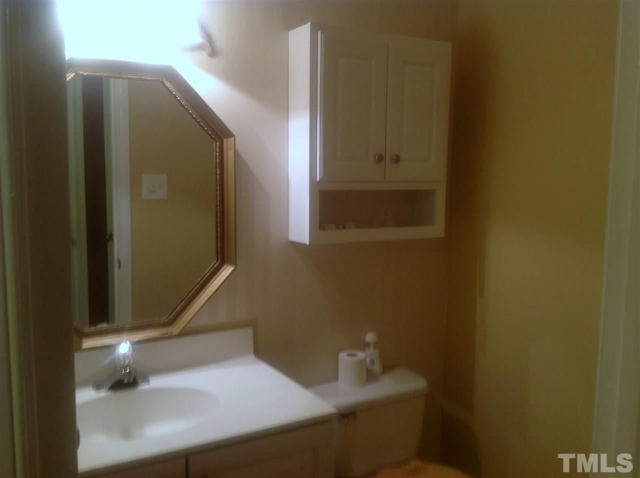 4238 Lake Ridge Drive, Unit 11C Raleigh, NC 27604 - Photo 8 of 12 a bathroom with a sink and a mirror