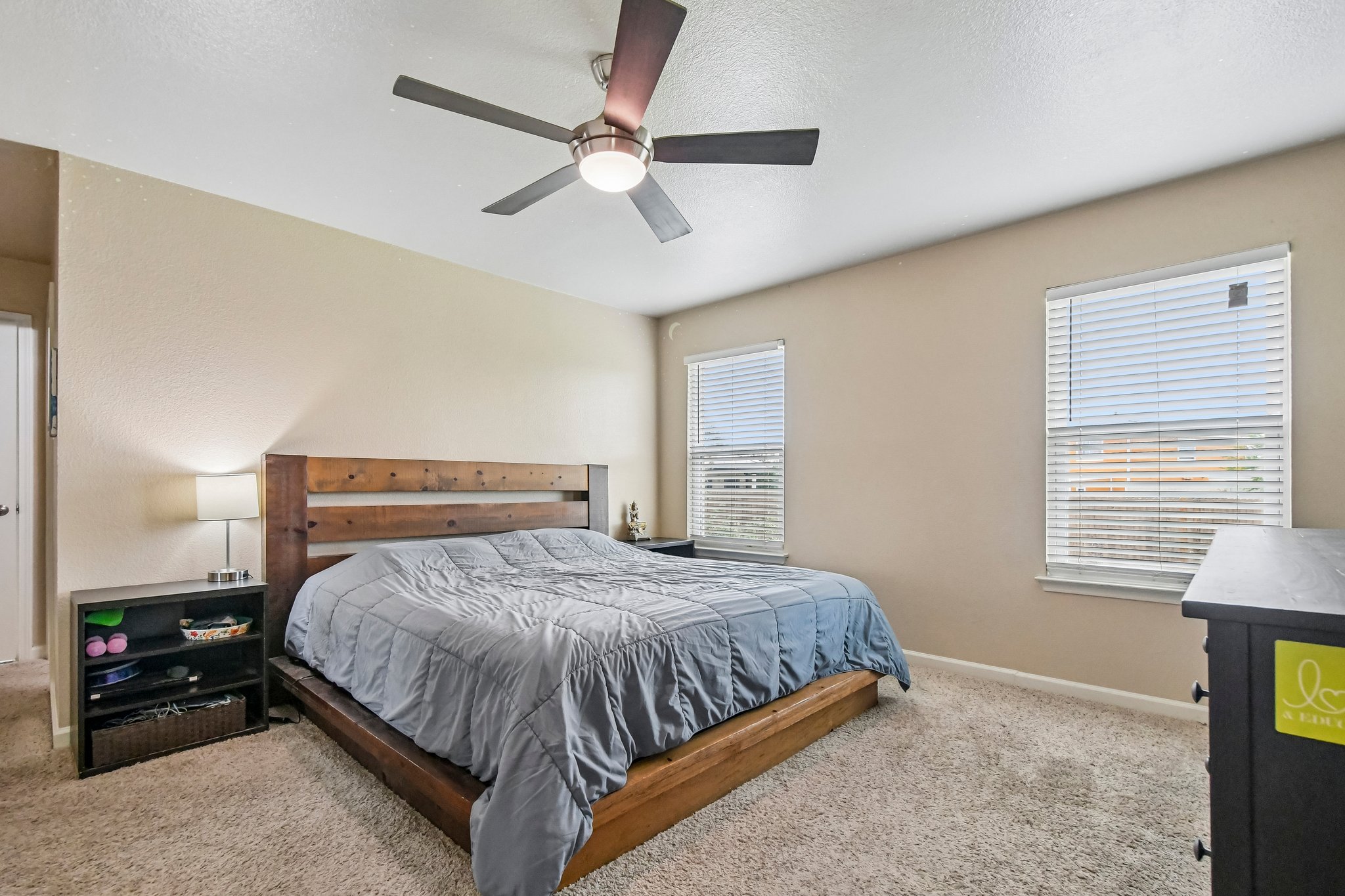 125 Mason Reed Cove Kyle, TX 78640 - Photo 32 of 39 a bedroom with a bed and a chandelier