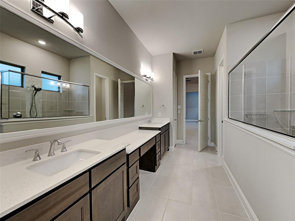 8262 Ottowa Ridge Frisco, TX 75034 - Photo 9 of 24 a bathroom with a sink double vanity granite tub shower and a mirror