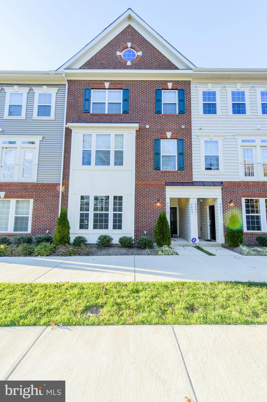 4878 Dane Ridge Circle, Unit 123 Woodbridge, VA 22193 - Photo 1 of 21 a front view of a residential apartment building with a yard