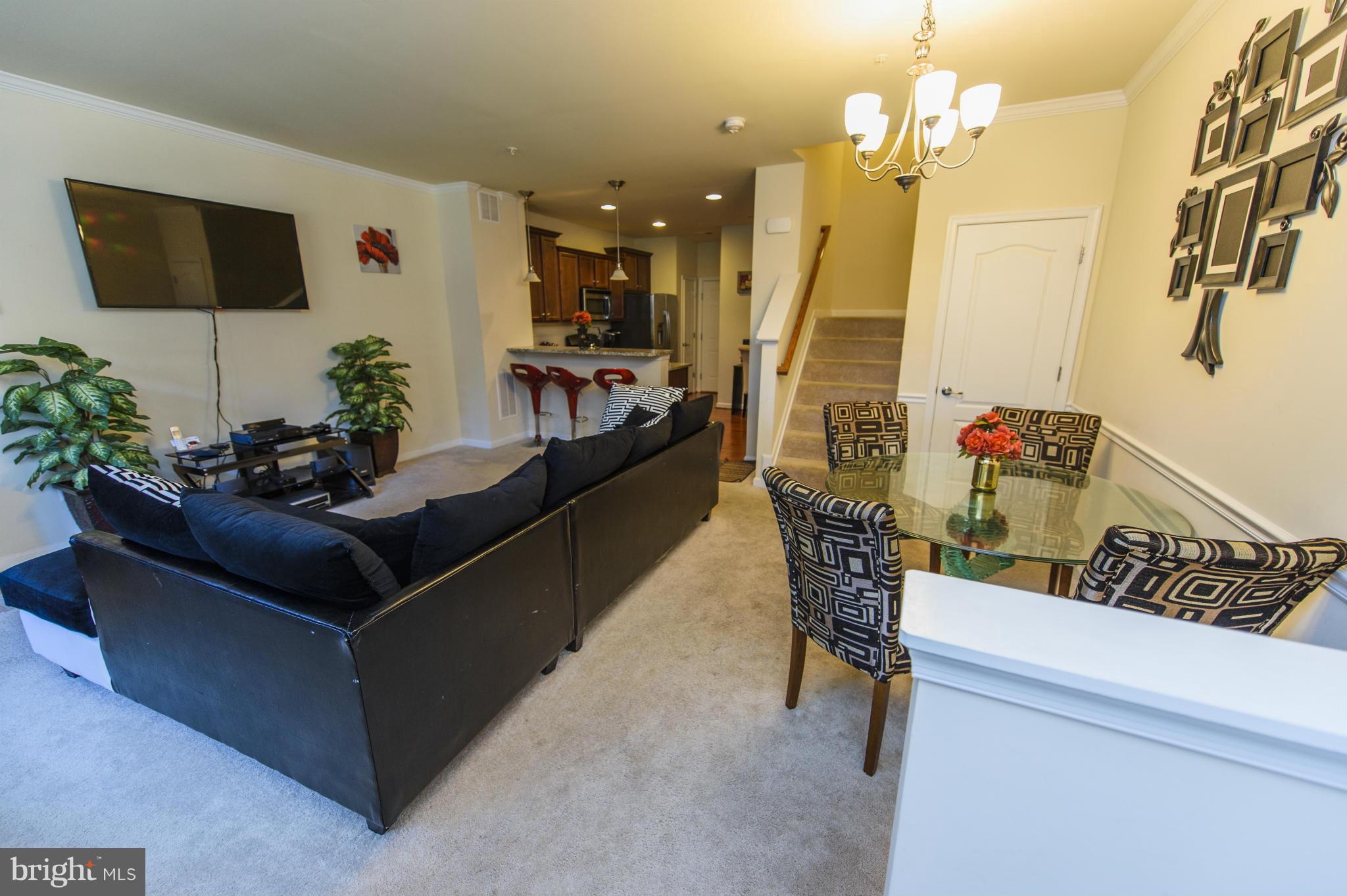 4878 Dane Ridge Circle, Unit 123 Woodbridge, VA 22193 - Photo 2 of 21 a living room with furniture and a flat screen tv