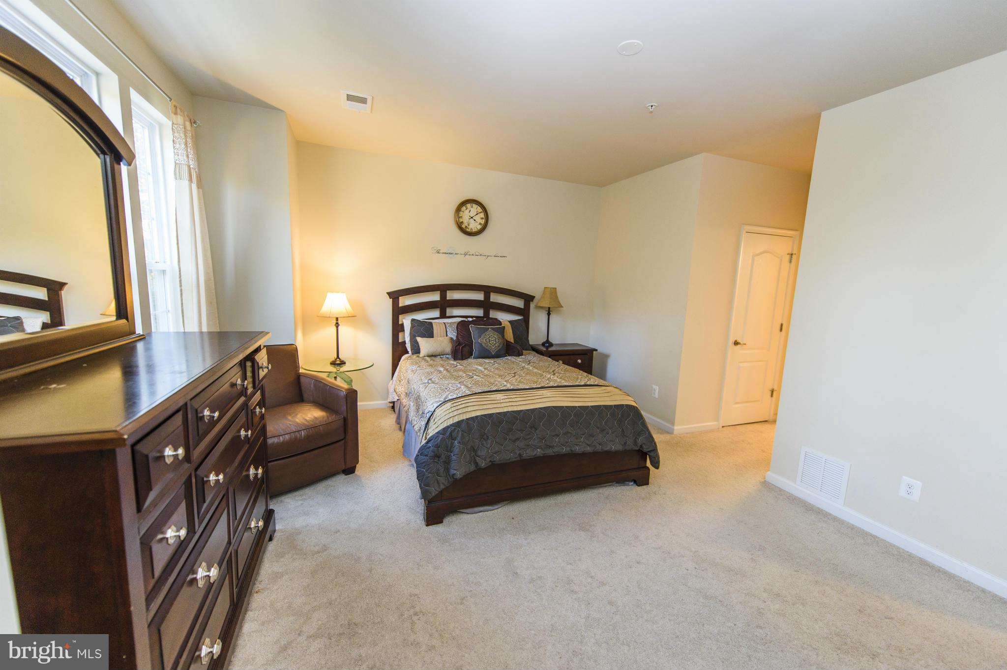 4878 Dane Ridge Circle, Unit 123 Woodbridge, VA 22193 - Photo 13 of 21 a bedroom with a bed dresser and a window