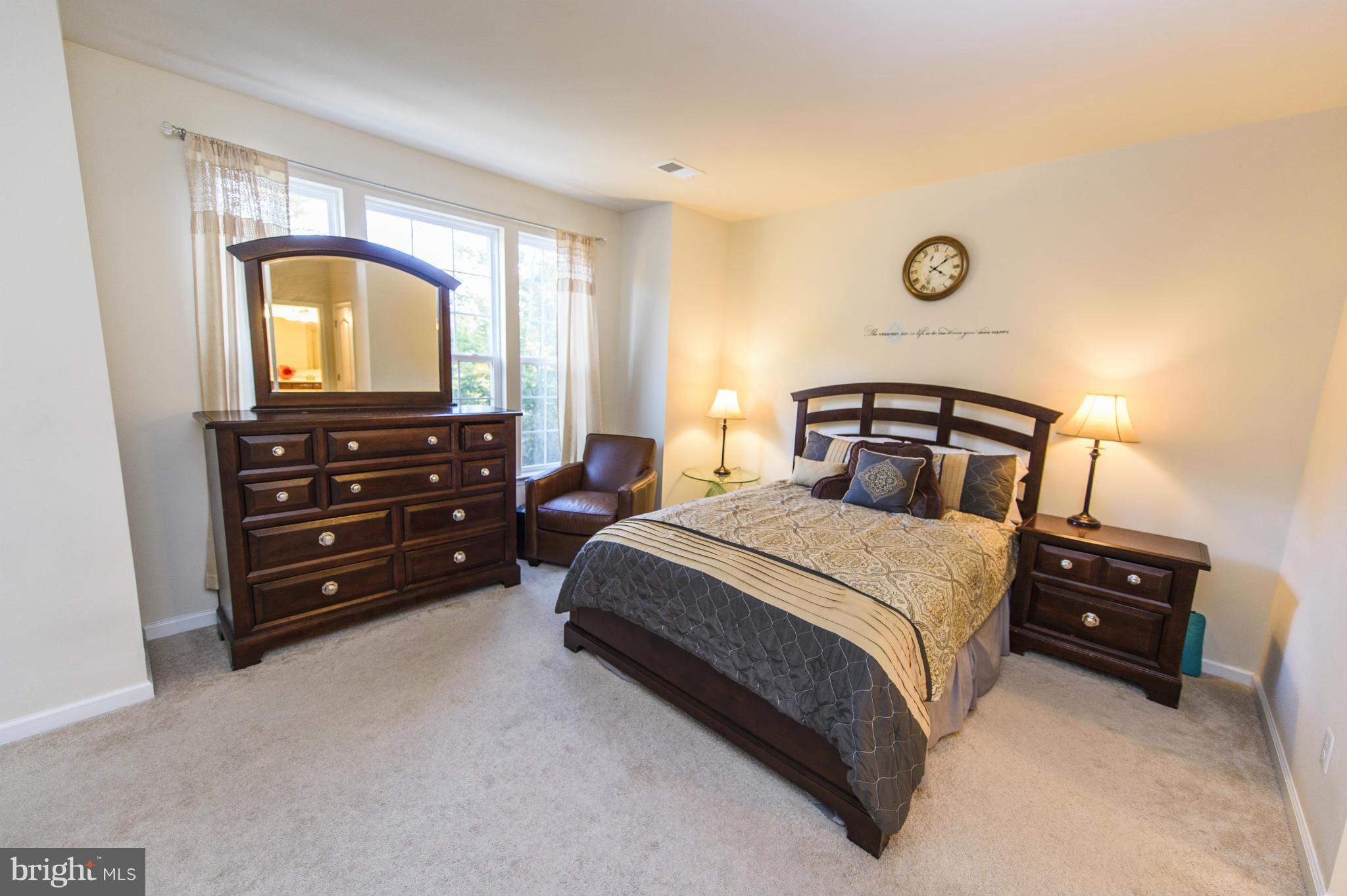 4878 Dane Ridge Circle, Unit 123 Woodbridge, VA 22193 - Photo 14 of 21 a bedroom with a bed and a dresser