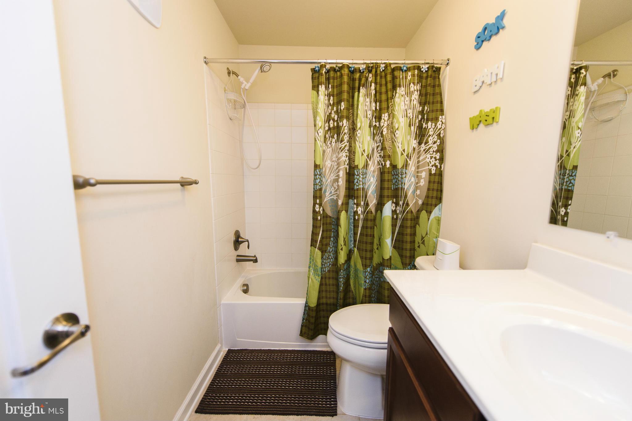 4878 Dane Ridge Circle, Unit 123 Woodbridge, VA 22193 - Photo 19 of 21 a bathroom with a sink a toilet and shower