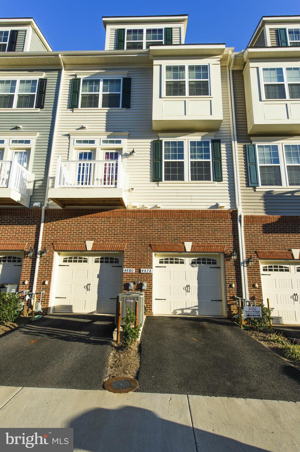 4878 Dane Ridge Circle, Unit 123 Woodbridge, VA 22193 - Photo 20 of 21 a front view of a residential apartment building with a yard